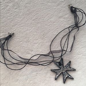 Glass work cross necklace.